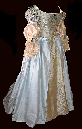 side profile of blue-gold 17th century dress with lace cuffs and ribbon detail