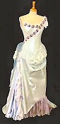 Asymmetrically decorated wedding dress with draped skirt, antique lace and corsetted bodice.