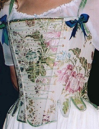A highly decorative eighteenth
century style corset / stays in a brocade fabric, lined and bound in silk
dupion with false front lacing, silk bound tabs and a beaded stomacher.Fully
boned; laced at the back and shoulder.