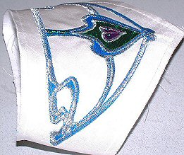 Detail of the applied Art Nouveau motifs in royal blue, green and wine silk, highlighted in silver .