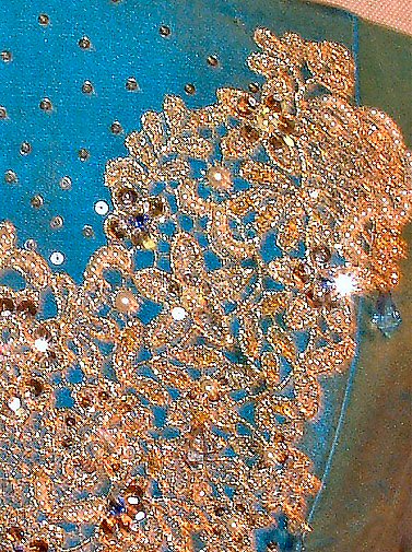 Gold lace and beading detail overgreen/ blue silk.    