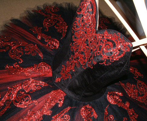 detail of red decoration on black and red classical ballet tutu