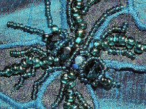 Close-up of the beaded butterfly worked in iridescent beads and crystals.