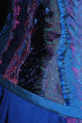 detail of multi-fabric textured corset in blues