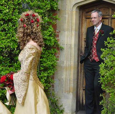 gold with red contrasts medieval style wedding dress with hanging sleeves