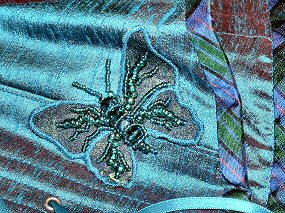Appliquéd and beaded butterfly as corset trim
