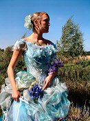 Alternative style corseted wedding gown in silk dupion with ruched organza skirt, embellished with silk flowers, antique beadwork, lace and butterflies.