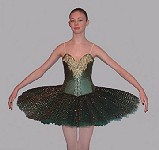 A made-to-measure classical ballet tutu designed as a competition costume. The twelve layered skirt is supported by a hoop to give a flattering 'pancake' effect and to withstand extremes of choreography. It is overlaid with pleated lace. Shown in emerald green, the silk bodice is elaborately decorated with suitably eye-catching gold detailing, highlighted with sequins and light-reflecting stones. 
As with all Rossetti tutus, this costume can be made to your specifications; fabric, decoration and colour can be varied (please enquire). 
