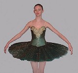 A made-to-measure classical ballet tutu designed as a competition costume. The twelve layered skirt is supported by a hoop to give a flattering 'pancake' effect and to withstand extremes of choreography. It is overlaid with pleated lace. Shown in emerald green, the silk bodice is elaborately decorated with suitably eye-catching gold detailing, highlighted with sequins and light-reflecting stones. 
As with all Rossetti tutus, this costume can be made to your specifications; fabric, decoration and colour can be varied (please enquire). 
