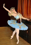 pale blue and plum decorated in gold. This costume was designed to be suitable for the role of Raymonda, the Hungarian princess. The skirt is elaborately appliqud in gold on a pale blue background, providing a rich contrast with the deep plum velvet bodice also decorated in gold to reflect her regal status. (This tutu is equally suited to the role of Paquita.)