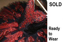 black and red tutu decorated in glittering red scrolling embellishment